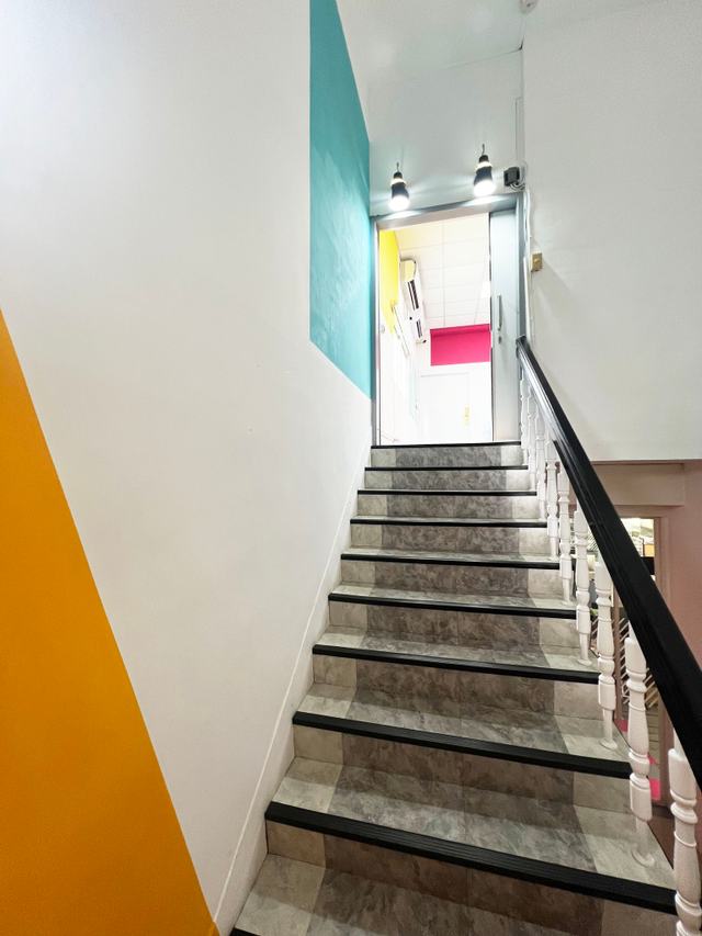 Staircase connecting floors 2 and 3 at Alliance Park A1 Zone, with a sliding fire door at the floor 3 entrance
