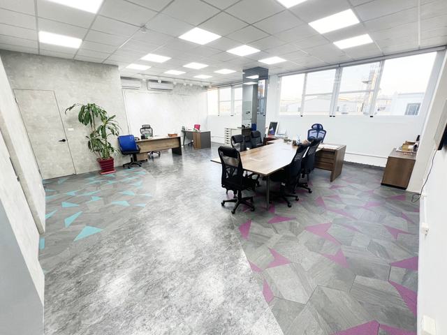 View from the entrance of the large partitioned room on floor 3 at Alliance Park A1 Zone, featuring a private restroom and whiteboard, with ample space for a conference table; suitable for an executive office or meeting room