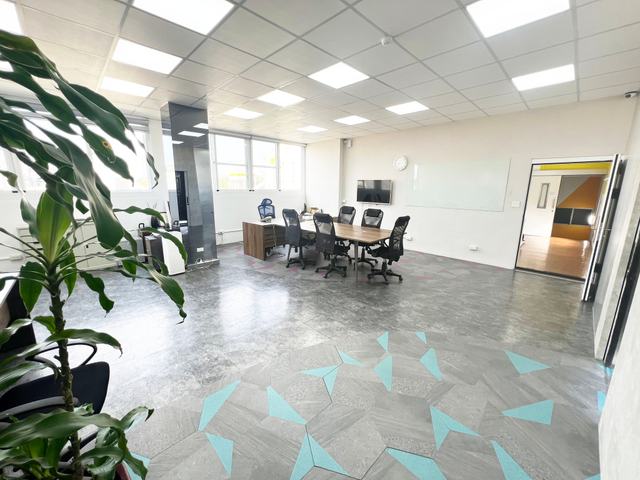 View from the restroom side of the large partitioned room on floor 3 at Alliance Park A1 Zone, featuring a private restroom and whiteboard, with ample space for a conference table; suitable for an executive office or meeting room
